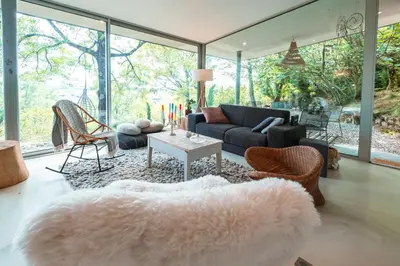 a living room with a couch and a table at Évasion champêtre à Horizon P'y - Piscine in Puéchoursi