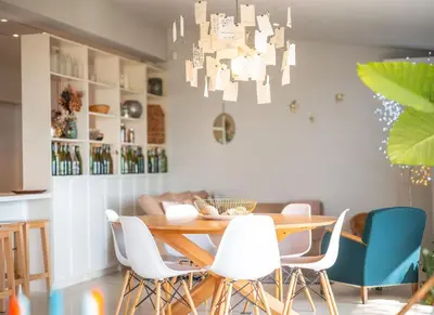 a dining room with a wooden table and white chairs at Évasion champêtre à Horizon P'y - Piscine in Puéchoursi