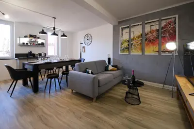 a living room with a couch and a dining room table at Magnifique*T4*centre ville*WIFI*Billard*Netflix* in Limoux