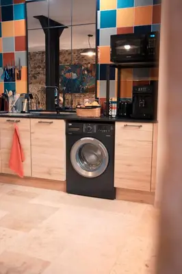 a kitchen with a washing machine in a kitchen at Le1693 - Charme & confort 4 étoiles - Jacuzzi in Limoux