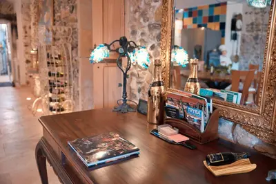 a table with a mirror and a book on it at Le1693 - Charme & confort 4 étoiles - Jacuzzi in Limoux