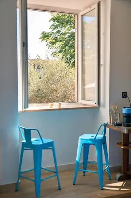 two blue chairs sitting in front of a window at Le1693 - Charme & confort 4 étoiles - Jacuzzi in Limoux