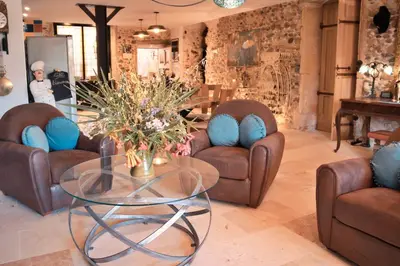 a living room with couches and a glass table at Le1693 - Charme & confort 4 étoiles - Jacuzzi in Limoux