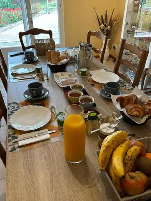 a table with breakfast foods and a glass of orange juice at Oasis Des Corbières in Boutenac