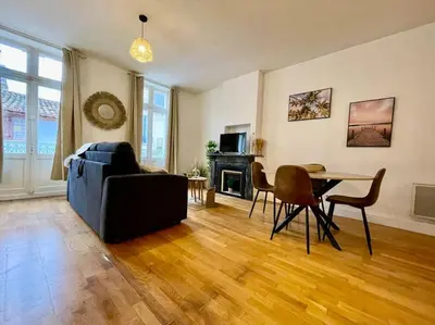 a living room with a couch and a table at Le Petit Balcon de Verdun - Carcassonne centre in Carcassonne