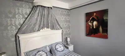 a bedroom with a bed and a picture on the wall at Suite Napoléon - La Halte d'Eugénie in Félines-Termenès