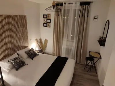a bedroom with a white bed and a window at T4 Lumineux proche Centre Ville Narbonne & Des Grands Buffets 2 étoiles in Narbonne