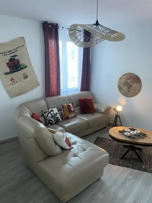 a living room with a couch and a table at T4 Lumineux proche Centre Ville Narbonne & Des Grands Buffets 2 étoiles in Narbonne