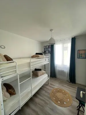 a bedroom with two bunk beds and a window at T4 Lumineux proche Centre Ville Narbonne & Des Grands Buffets 2 étoiles in Narbonne