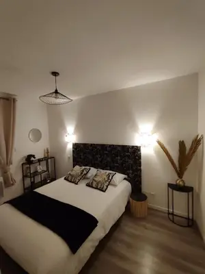 a bedroom with a large bed with two pillows at T4 Lumineux proche Centre Ville Narbonne & Des Grands Buffets 2 étoiles in Narbonne