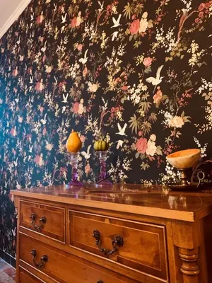 a wooden dresser with a floral pattern on a wall at La Babayaga in Capestang