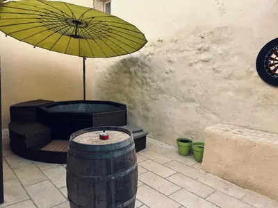 a yellow umbrella and a chair and a barrel at La Babayaga in Capestang