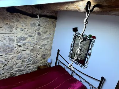 a chandelier hanging from the ceiling of a bedroom at Love room de Blanche Neige in Assignan