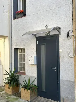 a door to a building with plants in front of it at Studio Sanae in Lézignan-Corbières