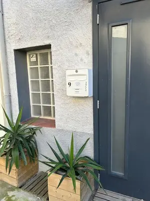 a small living room with a table and a couch at Studio Sanae in Lézignan-Corbières