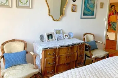 a bedroom with a dresser and two chairs and a bed at Bijou- Charming Traditional Home with Pool in Minervois in Saint-Jean-de-Minervois