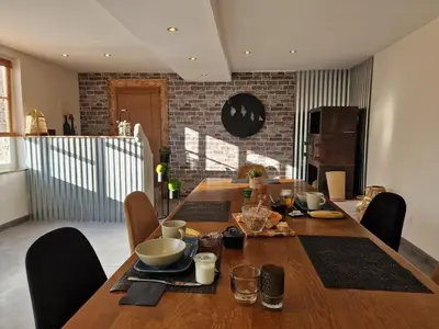 a wooden table with chairs and a dining room at Lodge tente les pommiers Glamping Ô rendez-vous en demi-pension in Roquefeuil