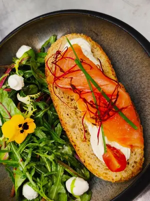 a plate of food with a sandwich and a salad at Lodge tente les pommiers Glamping Ô rendez-vous en demi-pension in Roquefeuil