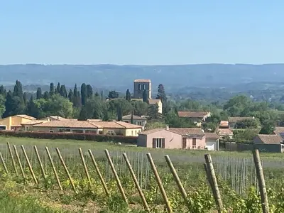 a village in a field with a fence at Maison RASSIER, Gîte Vélo in Sainte-Eulalie