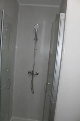a shower in a bathroom with a glass door at Bel Appartement T2 in Carcassonne