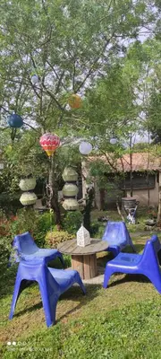 two blue chairs and a picnic table in a yard at Chez Claudie et Jacques in Ventenac-Cabardès