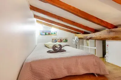 a bedroom with a bed with an animal on it at Chez Claudie et Jacques in Ventenac-Cabardès