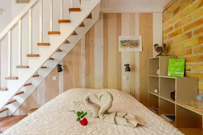 a bedroom with a bed and a staircase at Chez Claudie et Jacques in Ventenac-Cabardès