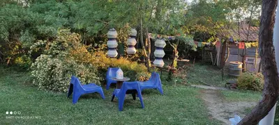 a group of blue chairs and a table in a yard at Chez Claudie et Jacques in Ventenac-Cabardès