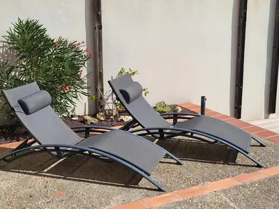 two chairs sitting on the side of a house at Superb villa for 4, private pool in Durban-Corbières