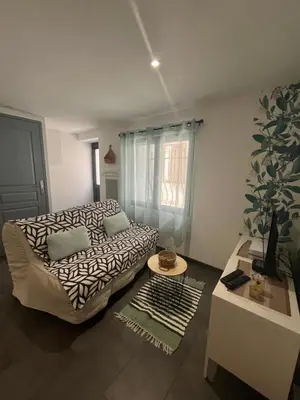 a living room with a couch and a table at Petite maison in Carcassonne