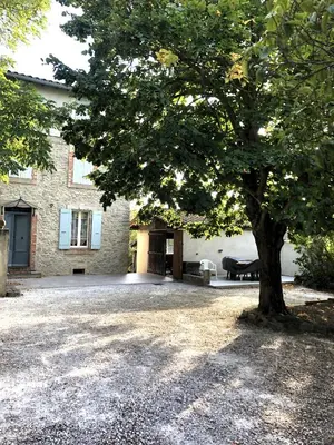 a large tree in front of a building at Le gîte du Clos d'André in Castelnaudary