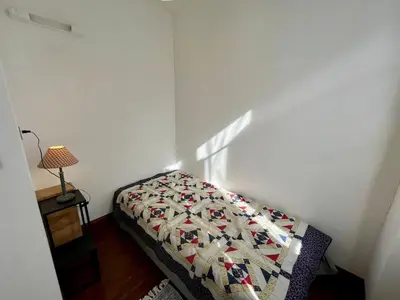 a bedroom with a bed with a quilt on it at Le gîte du Clos d'André in Castelnaudary