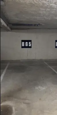 an empty parking lot with a sign that readsbos at T2 quartier Mermoz, 2 places de parking privées in Pamiers
