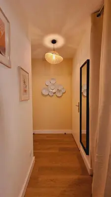 a hallway with a ceiling light and a room with a hallway at T2 quartier Mermoz, 2 places de parking privées in Pamiers