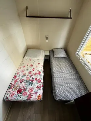 a kitchen with a white refrigerator and a sink at Entre Mer et Roseaux - Piscine chauffée - Proche centre et mer - Animaux bienvenus in Port-la-Nouvelle