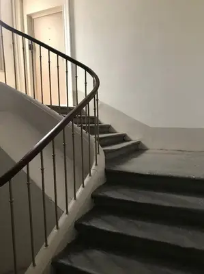 a set of stairs in a building with a door at Appartement avec terrasse centre de la Bastide in Carcassonne