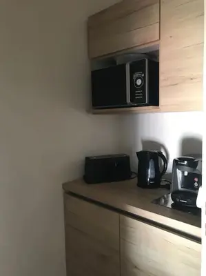 a kitchen with a counter top with a microwave at Appartement avec terrasse centre de la Bastide in Carcassonne