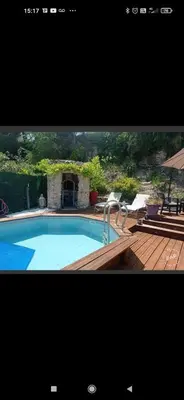 a picture of a swimming pool with two chairs at Les oliviers Puisserguier in Puisserguier