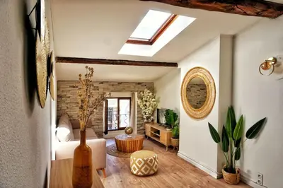 a living room with a skylight and a room with a couch at Emplacement N°1+Terrasse Vue+Cité+Trivalle+clim in Carcassonne