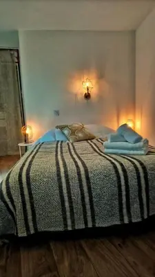 a bedroom with a bed with two towels on it at Emplacement N°1+Terrasse Vue+Cité+Trivalle+clim in Carcassonne