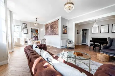 a living room with a large couch and a piano at 2 bedrooms apartment - Perfect for a city getaway in Carcassonne