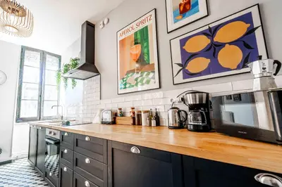a kitchen with a counter top with a microwave at 2 bedrooms apartment - Perfect for a city getaway in Carcassonne