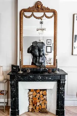 a mirror on top of a fireplace with a statue at 2 bedrooms apartment - Perfect for a city getaway in Carcassonne