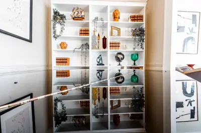 a glass display cabinet with vases on it at 2 bedrooms apartment - Perfect for a city getaway in Carcassonne