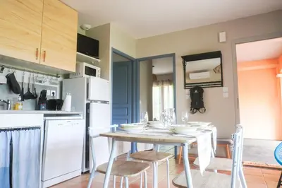 a kitchen and dining room with a table and chairs at Chez Francis & Valérie in Villegailhenc