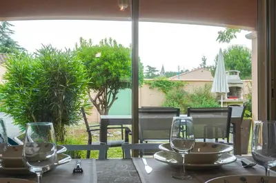 a table with wine glasses on top of it at Chez Francis & Valérie in Villegailhenc