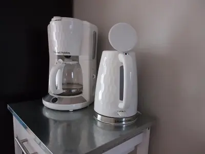 a counter with a coffee maker and a blender on it at Chez Francis & Valérie in Villegailhenc