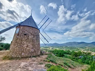 a stone windmill on top of a hill at Maison sur la place du marché à St Chinian in Saint-Chinian