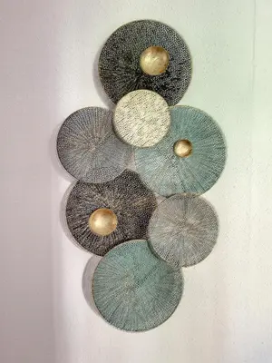 a group of five different colored plates on a wall at Maison sur la place du marché à St Chinian in Saint-Chinian