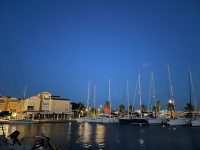 a group of boats docked in a marina at night at Symbiose sur l’eau Gruissan in Gruissan